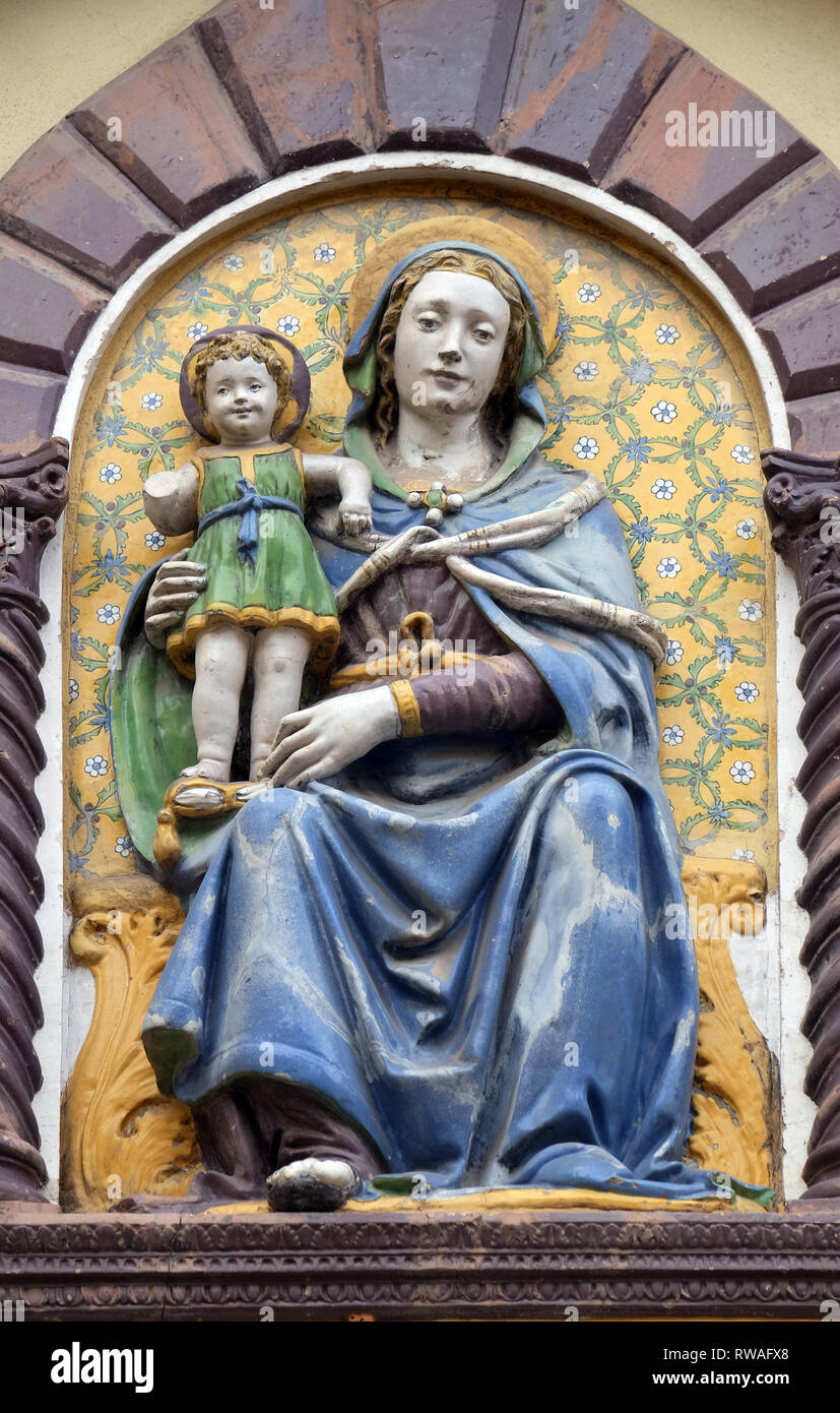 Madonna and Child by Giovanni Della Robbia on the portal of San Barnaba Church in Florence, Italy Stock Photo