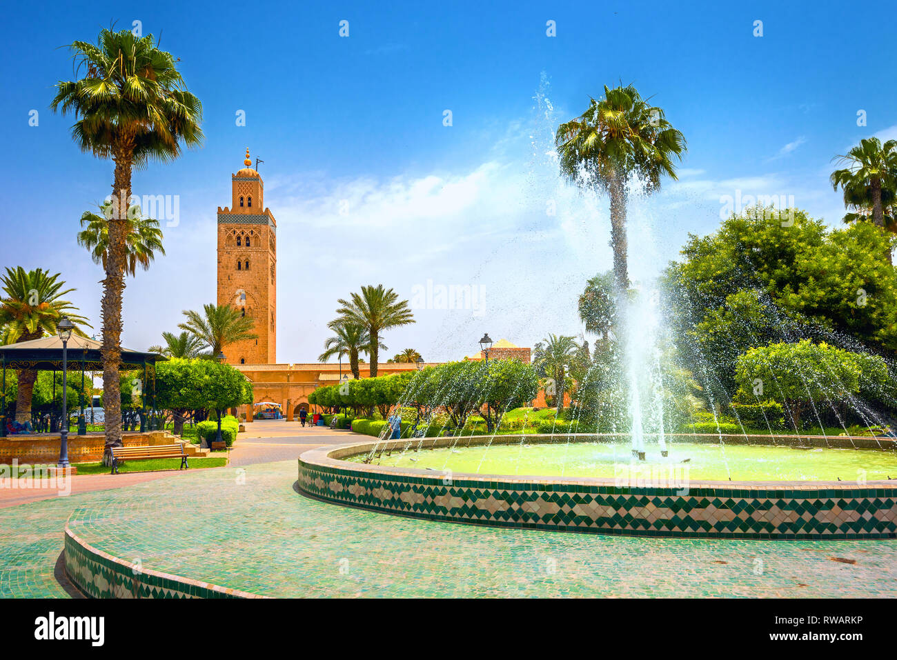 Scenic view from garden with fountain of minaret of Koutoubia Mosque in Marrakech. Morocco, North Africa Stock Photo