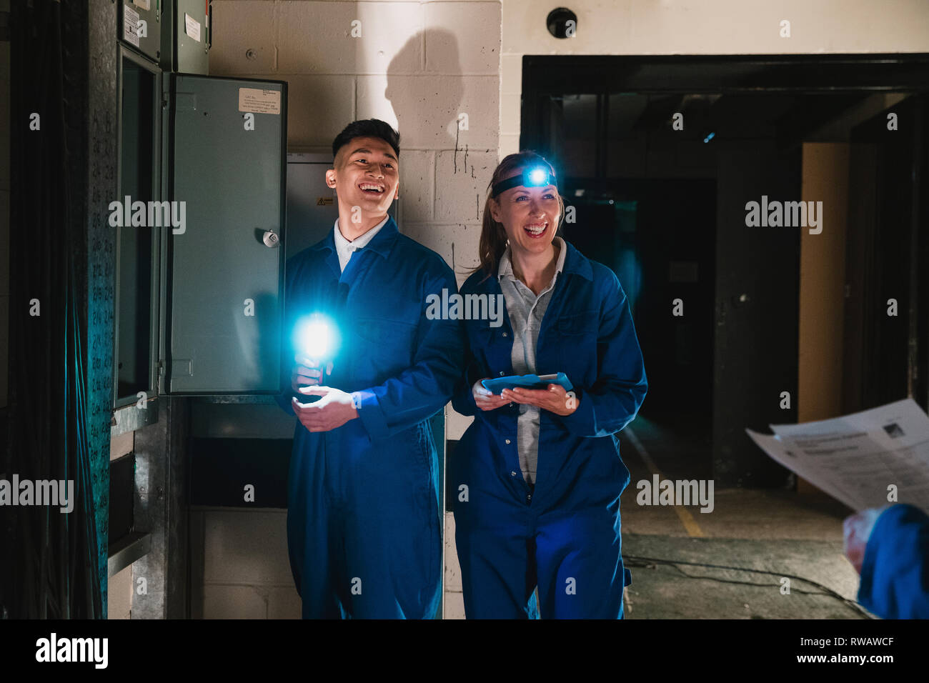 Trainee electricians are having fun in a lesson on wiring. Stock Photo