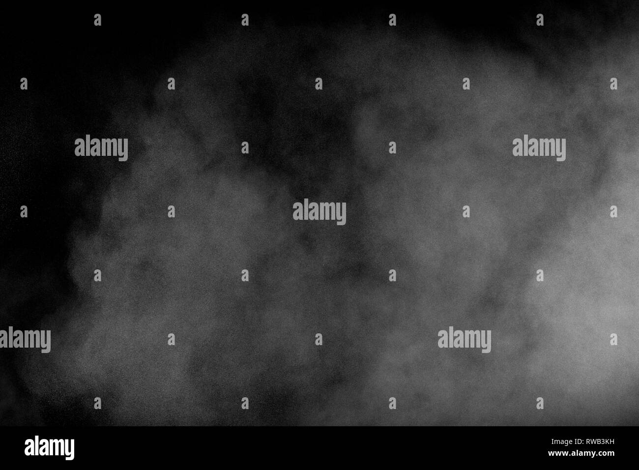 White dust exhale in the air. Motion powder spray burst in dark