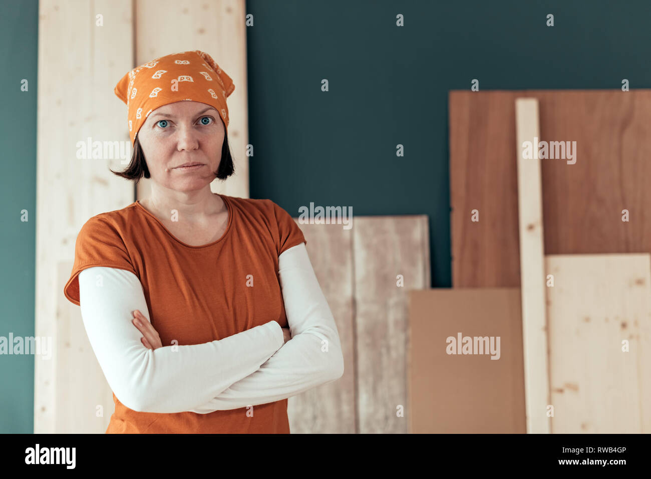 Confident self employed female carpenter portrait in her small business woodwork workshop Stock Photo