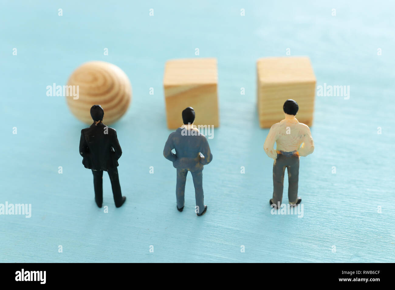 Concept photo of problem solving, three miniature people looking at ...