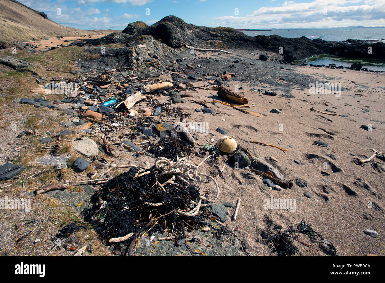 Plastic flotsam and debris washed up on the sandy beach of Shell Bay at Elie Fife Scotland Stock Photo