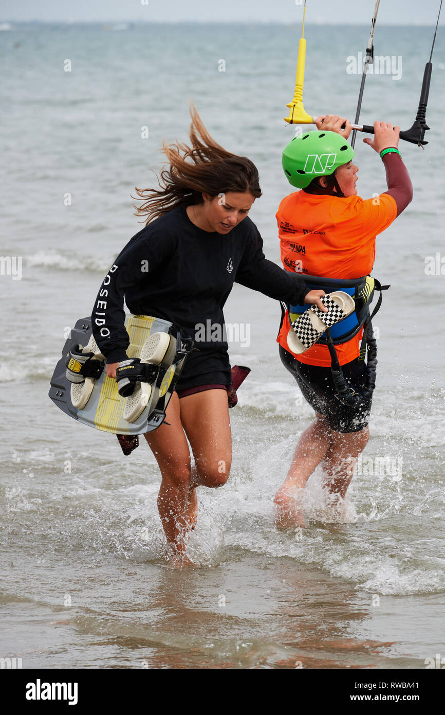 Armada Kiteboarding festival. Assisted run through the surf to reposition upwind. Stock Photo