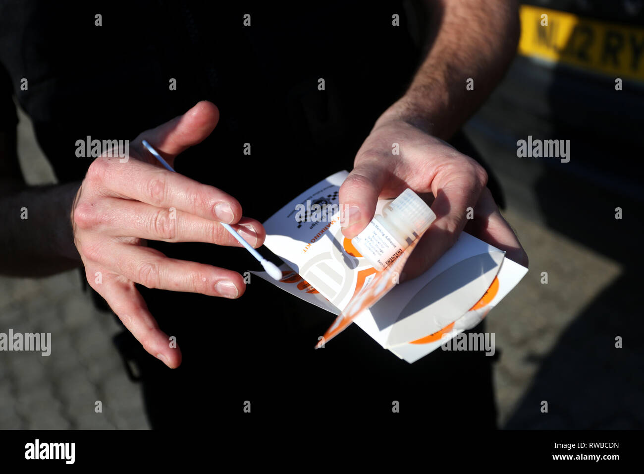 Police officers pictured marking up builders tools with some SelectaDNA
