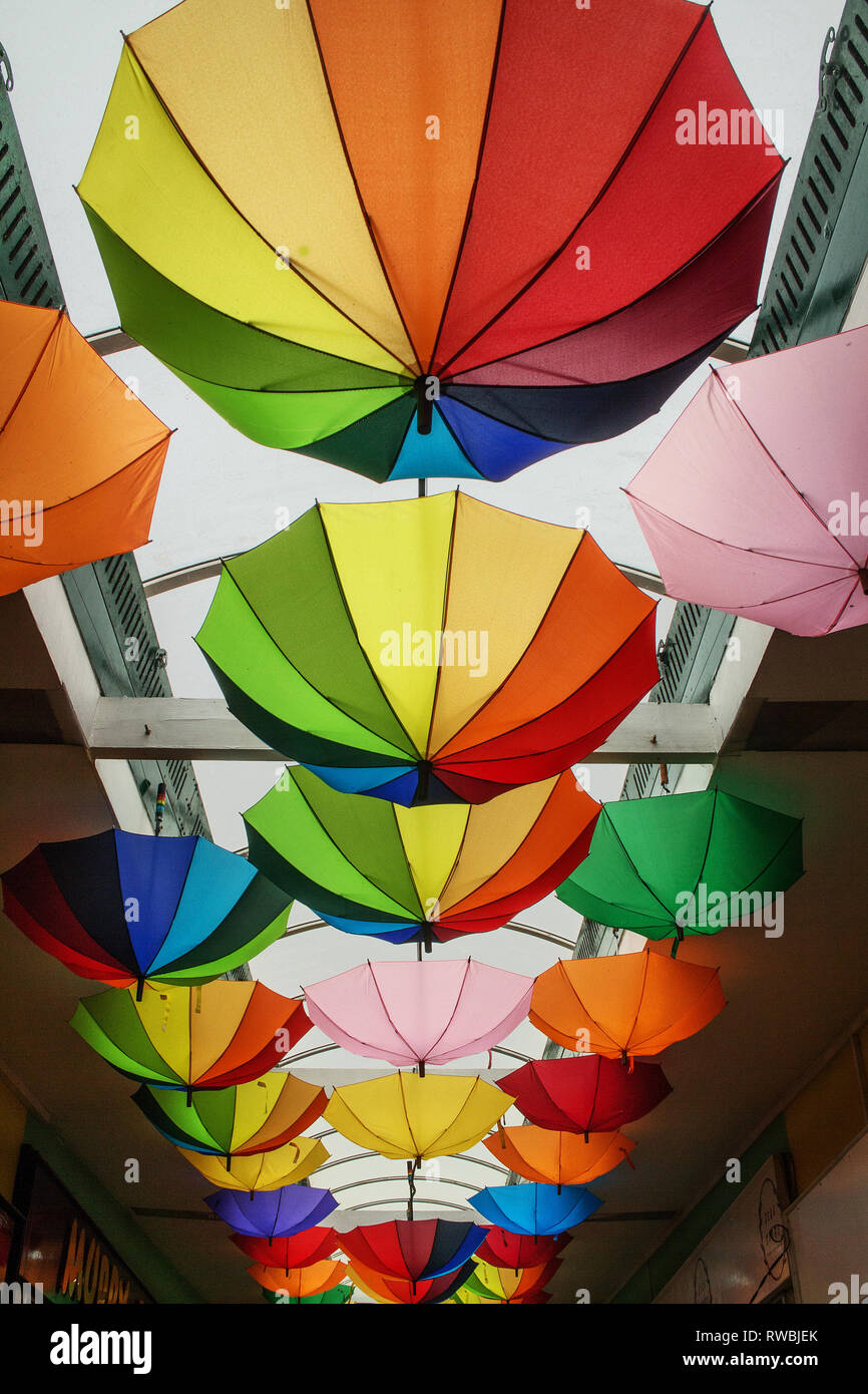 Coloured umbrellas suspended from the ceiling of an indoor shopping parade  Stock Photo - Alamy