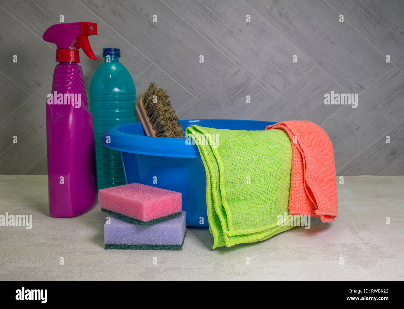 blue washing up dish with cleaning tools and detergents as degreaser