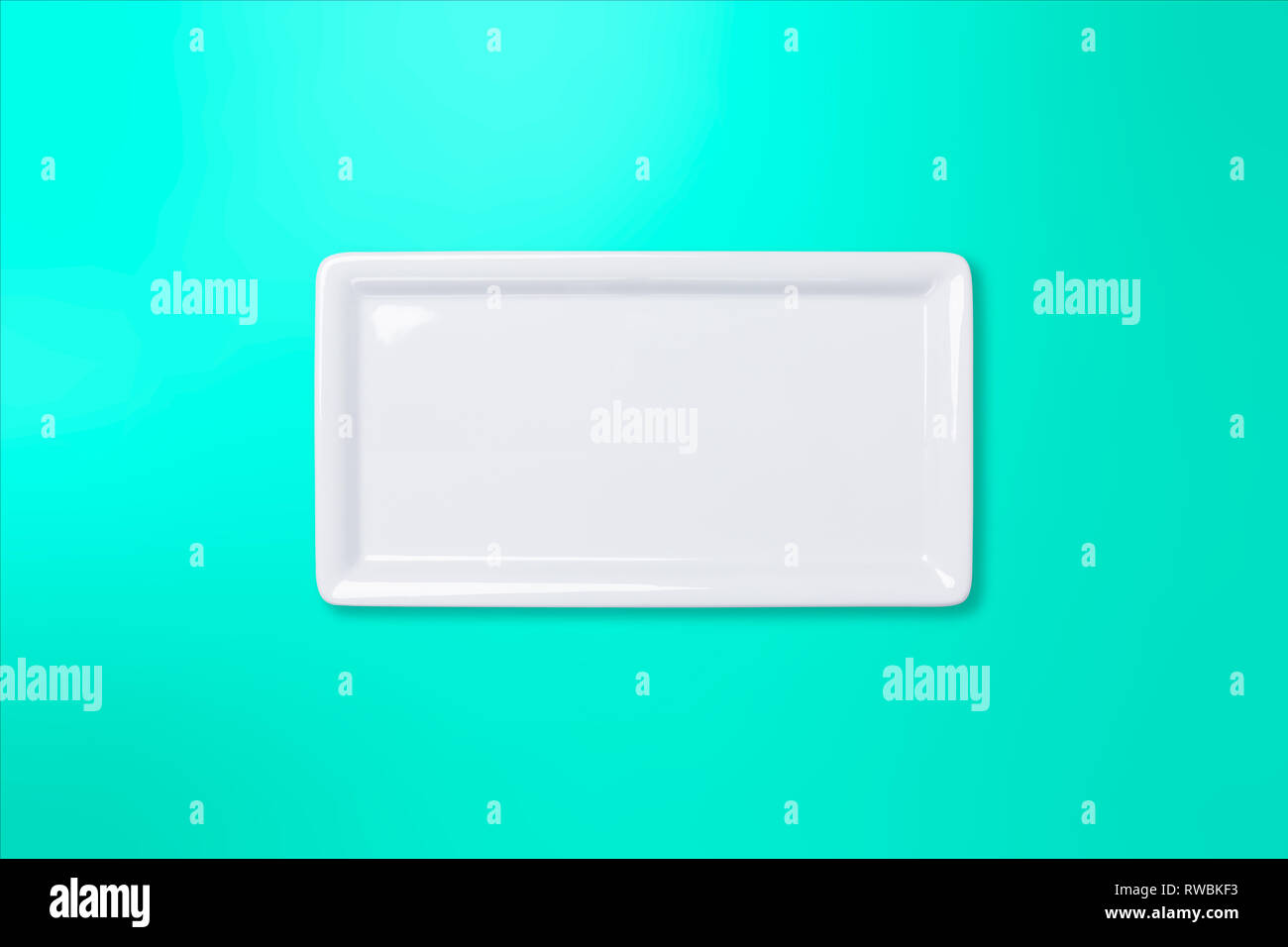 Empty white cornered plate on teal gradient background, view directly from above Stock Photo