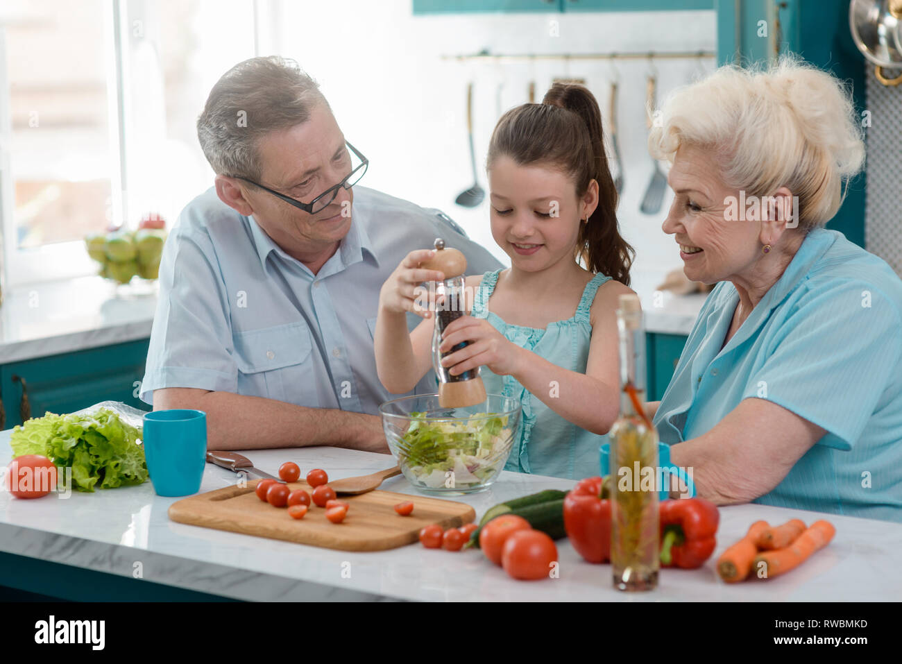 Proud grandparents and their granddaughter Stock Photo - Alamy