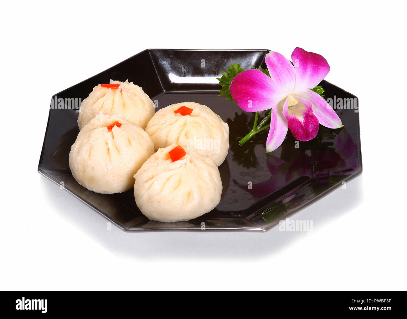 Chinese / Asian desserts served on a black plate. Stock Photo