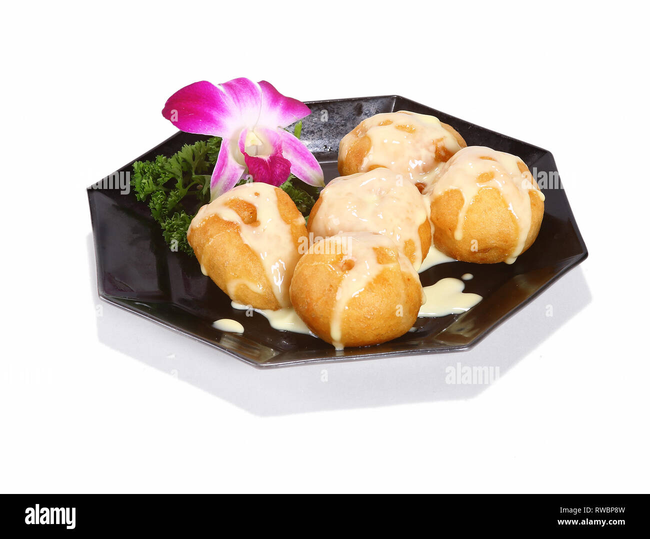 Chinese / Asian desserts served on a black plate. Stock Photo