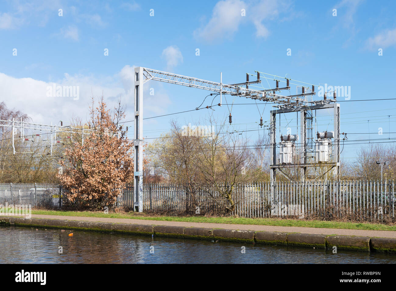 Over head power lines or cables on a railway track next to Birmingham Canal Old Line in Ladywood, Birmingham Stock Photo