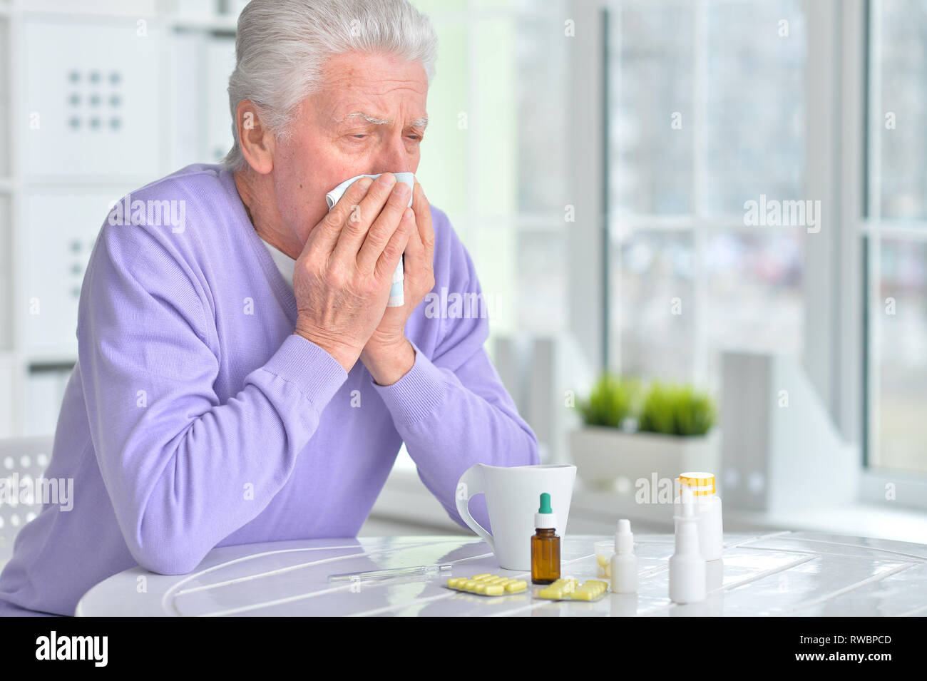 Portrait of sick senior man with pills posing Stock Photo