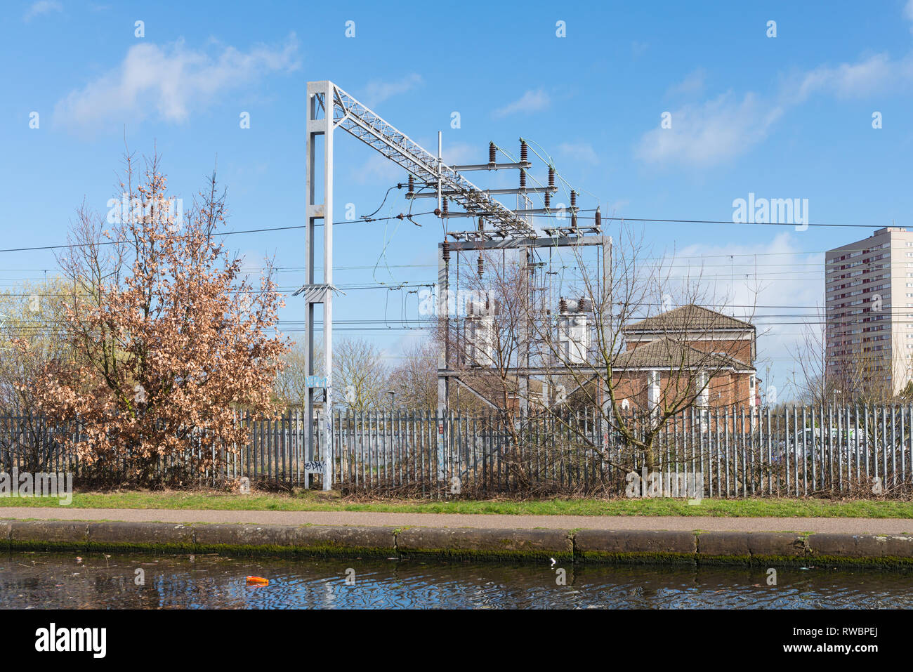 Over head power lines or cables on a railway track next to Birmingham Canal Old Line in Ladywood, Birmingham Stock Photo