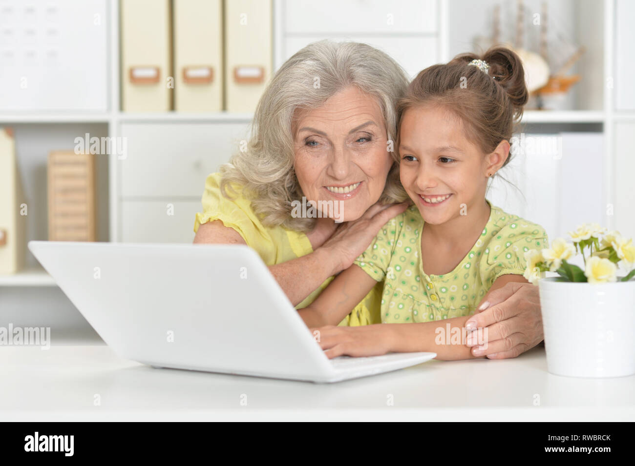Portrait of grandmother and daughter using laptop Stock Photo - Alamy