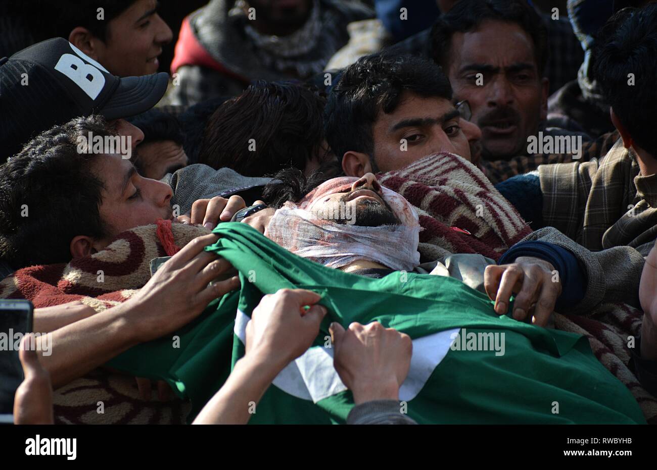 March 5, 2019 - Tral, Jammu and Kashmir, India - Dead body of a local militant Irfan Ahmad Rather is being carried by villagers in his native village Sharief Abad area of Tral some 45 kilometers from Srinagar, Kashmir on March 05, 2019.Indian security forces killed two militants when the gun-battle broke out between militants and government forces in Reshipora area of Tral in south Kashmir. (Credit Image: © Faisal KhanZUMA Wire) Stock Photo