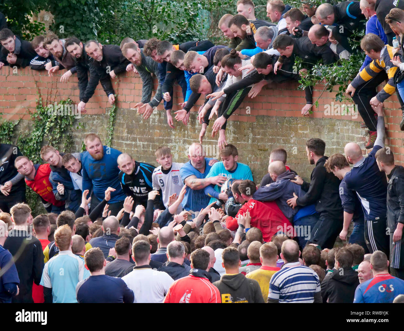 Ashbourne Derbyshire, UK. 5th Mar, 2019. Ashbourne Royal Shrovetide Football match on Shrove Tuesday. Ye Olde & Ancient Medieval hugball game is the forerunner to football. It's played between two teams, the Up'Ards & Down'Ards separated by the Henmore Brook river. The goals are 3 miles apart at Sturston Mill & Clifton Mill. Charles Cotton's poem Burlesque upon the Great Frost, dating from 1683, mentions this game at Ashbourne. He was the cousin of Aston Cockayne Baronet of Ashbourne, Derbyshire. Credit: Doug Blane/Alamy Live News Stock Photo