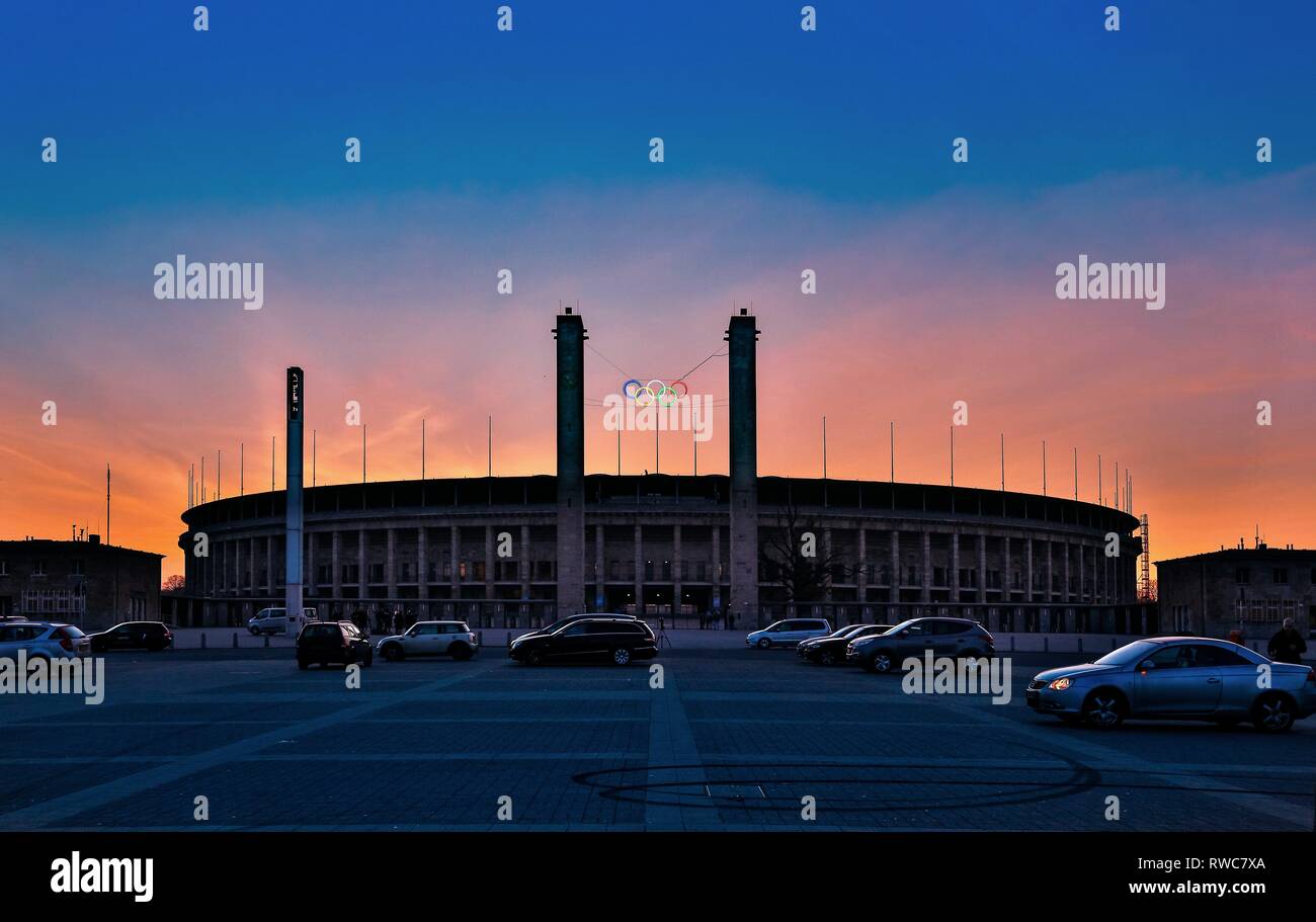 Berlin, Deutschland. 18th Feb, 2015. The Olympiastadion Berlin in the Berlin district of Westend in the dusk with a beautiful evening sky from the Olympic Square. The striking east gate with the two 35 meter high towers, the bavarian tower on the left (south) and the Prussian tower on the right (north), the five Olympic rings and the new Podbielskieiche. The stadium was designed by the architect Albert Speer and today is the home ground of the football Bundesliga team Hertha BSC. | usage worldwide Credit: dpa/Alamy Live News Stock Photo