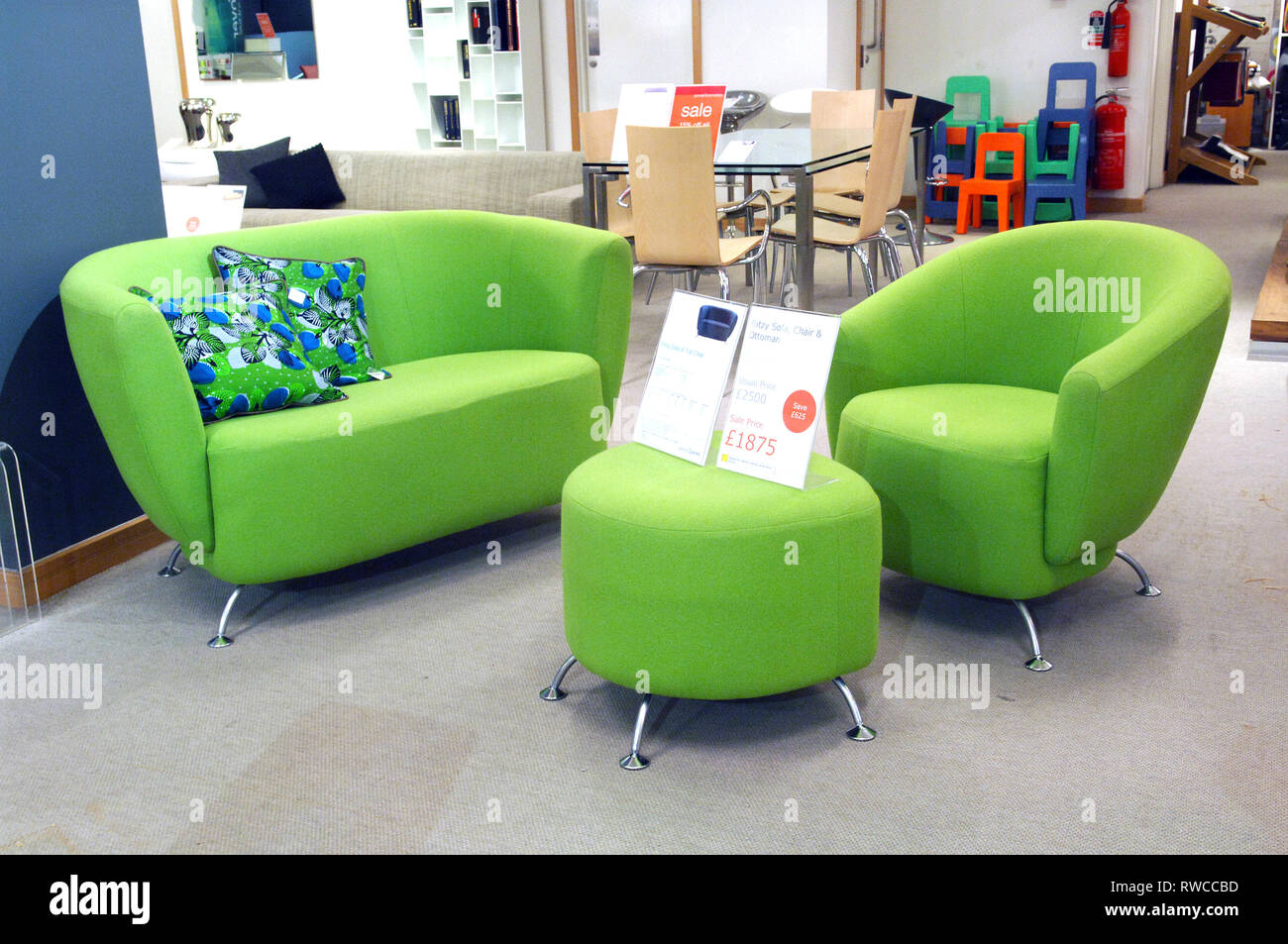 Green sofa, footstool and chair in a contemporary furniture shop Stock Photo Alamy