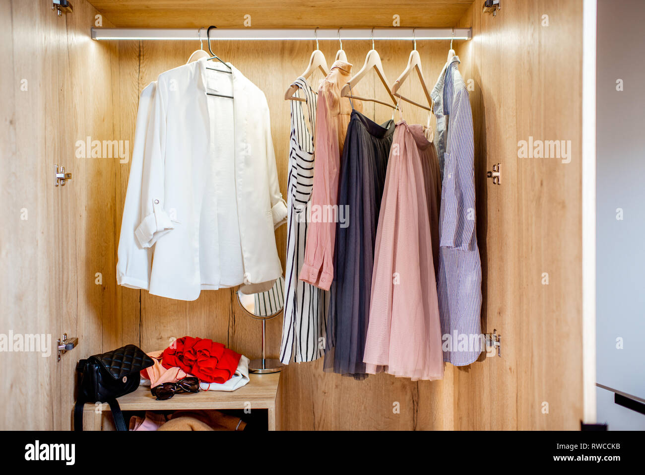 Wardrobe Full Of Female Clothes And Shoes At Home Stock Photo