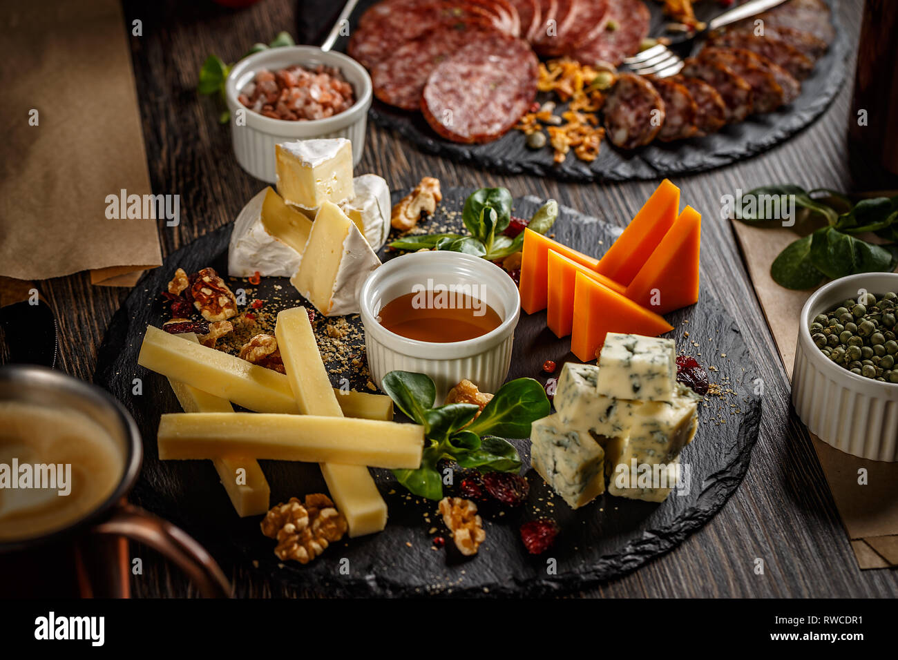 Appetizer table with antipasto snacks. Cheese and meat variety board over wooden background Stock Photo