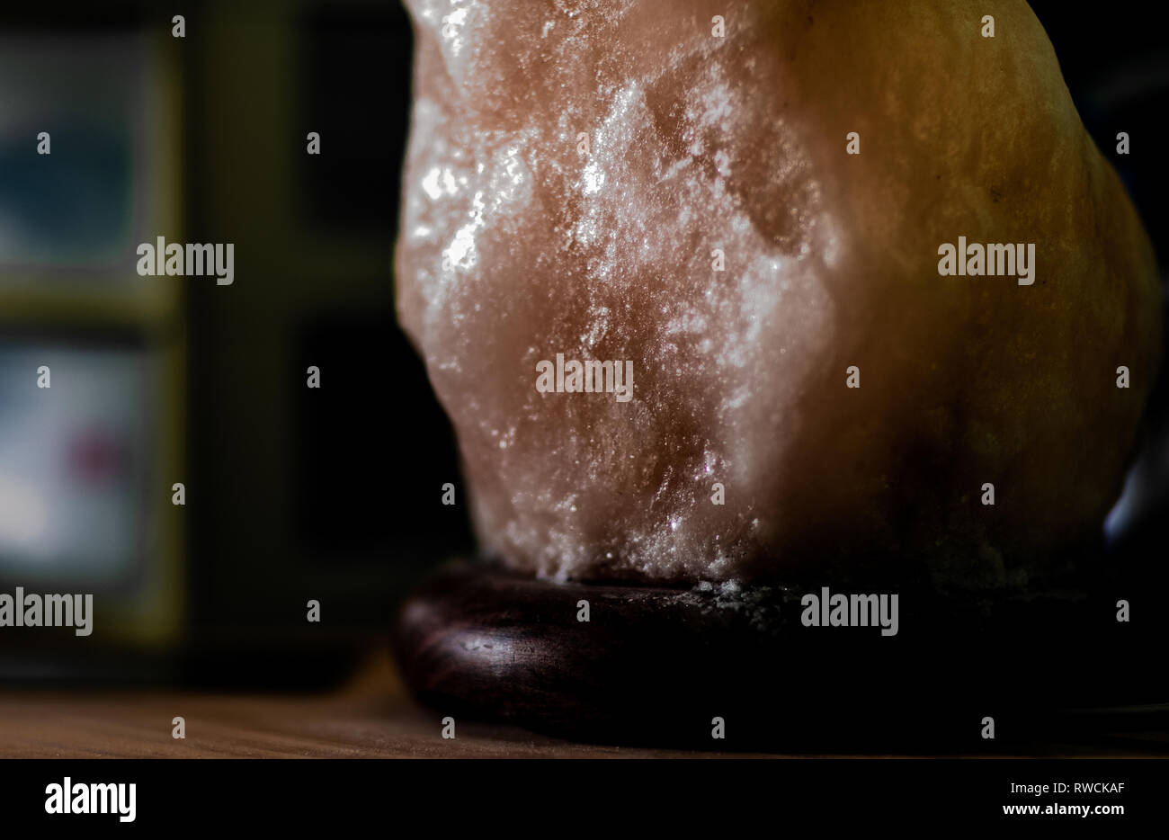 Himalayan Salt Lamp on Wood Surface Stock Photo
