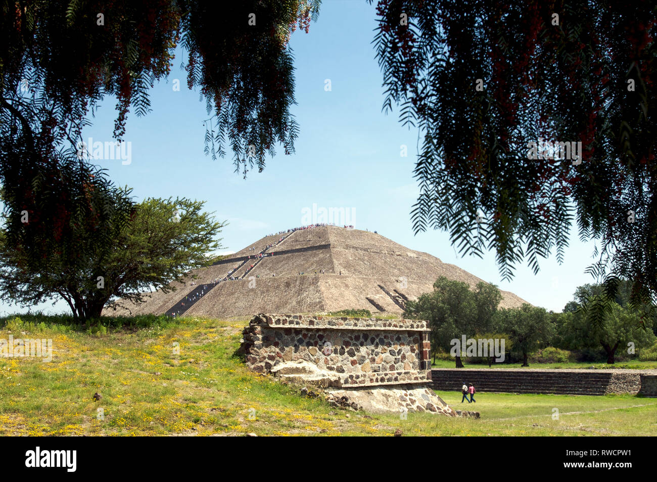 View of the Pyramid of the Sun and people walking on the Avenue of the Dead with tourists at Teotihuacan, Mexico Stock Photo