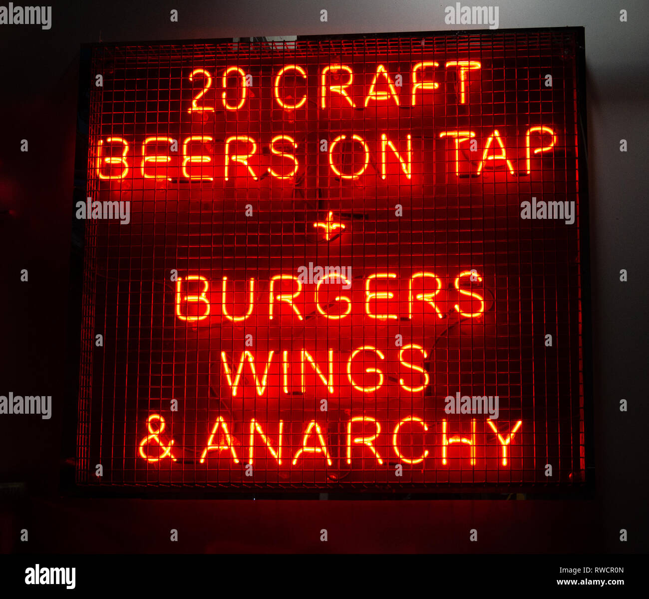 Neon sign, 20 Craft Beers on Tap + Burgers Wings & Anarchy, London, UK Stock Photo