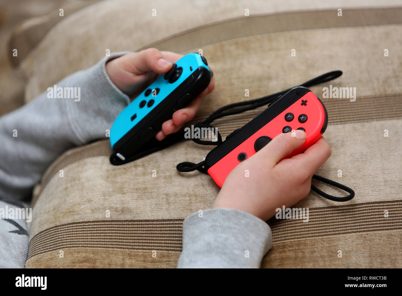 A young girl pictured playing on a Nintendo Switch games console at her  home in London, UK Stock Photo - Alamy