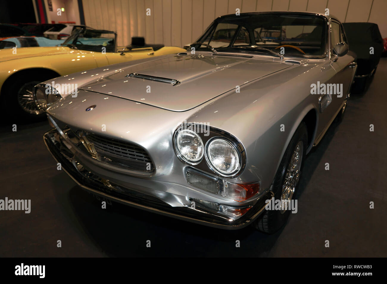 Three-quarter front view of a Silver, 1966, Maserati Sebring Series 2, on display in the Paddock Area of the 2019 London Classic Car Show Stock Photo