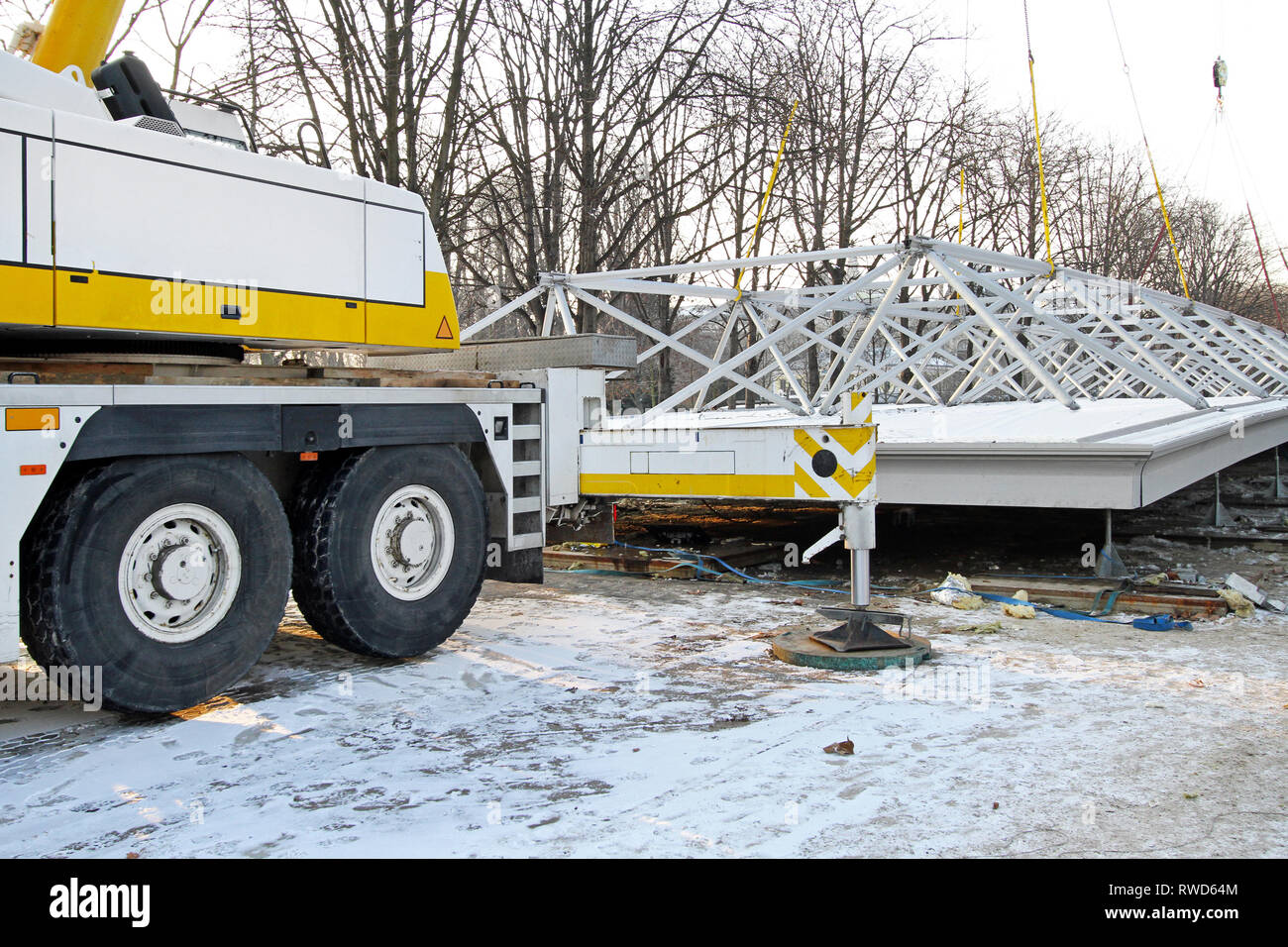 Crane Truck Lifting Heavy Steel Structure at Construction Site Stock Photo  - Alamy