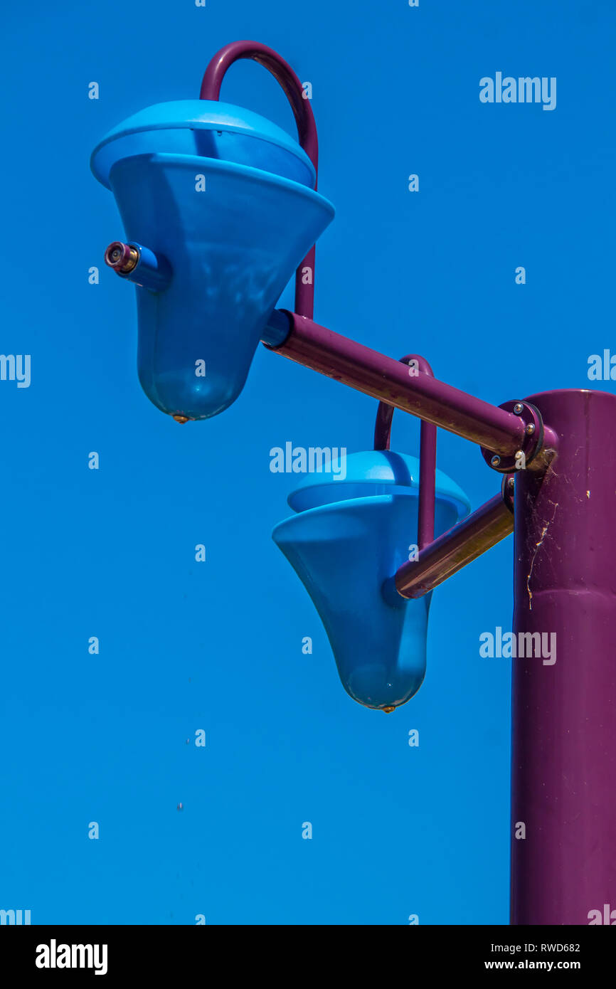 Blue plastic bucket dumping water at a water park Stock Photo - Alamy