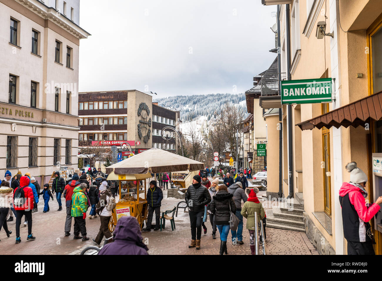 Zakopane, Poland - February 22, 2019. A crowd of people is walking along Krupowki street on an winter day. Krupowki street is the main city promenade Stock Photo