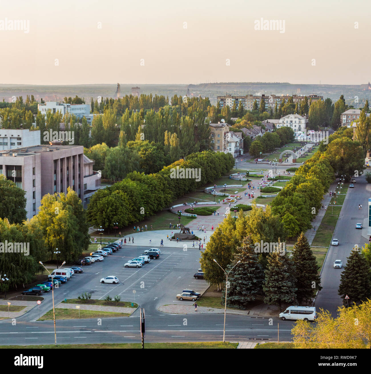 A Kriviy Rih city view. Cityscape at the sunset. A square with chestnut trees alley. City council building. Ukraine. View from the roof. Stock Photo