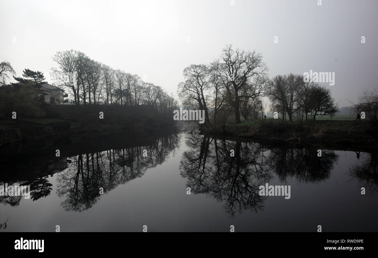 Trees are reflected in the River Wharfe in the morning light in Wetherby, Yorkshire, Britain February 25, 2019. John Voos/TSL Stock Photo