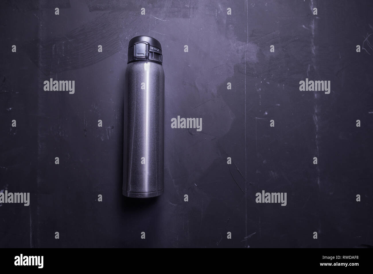 Thermal bottle. Thermos to save heat. Shiny iron bottle. Top view on