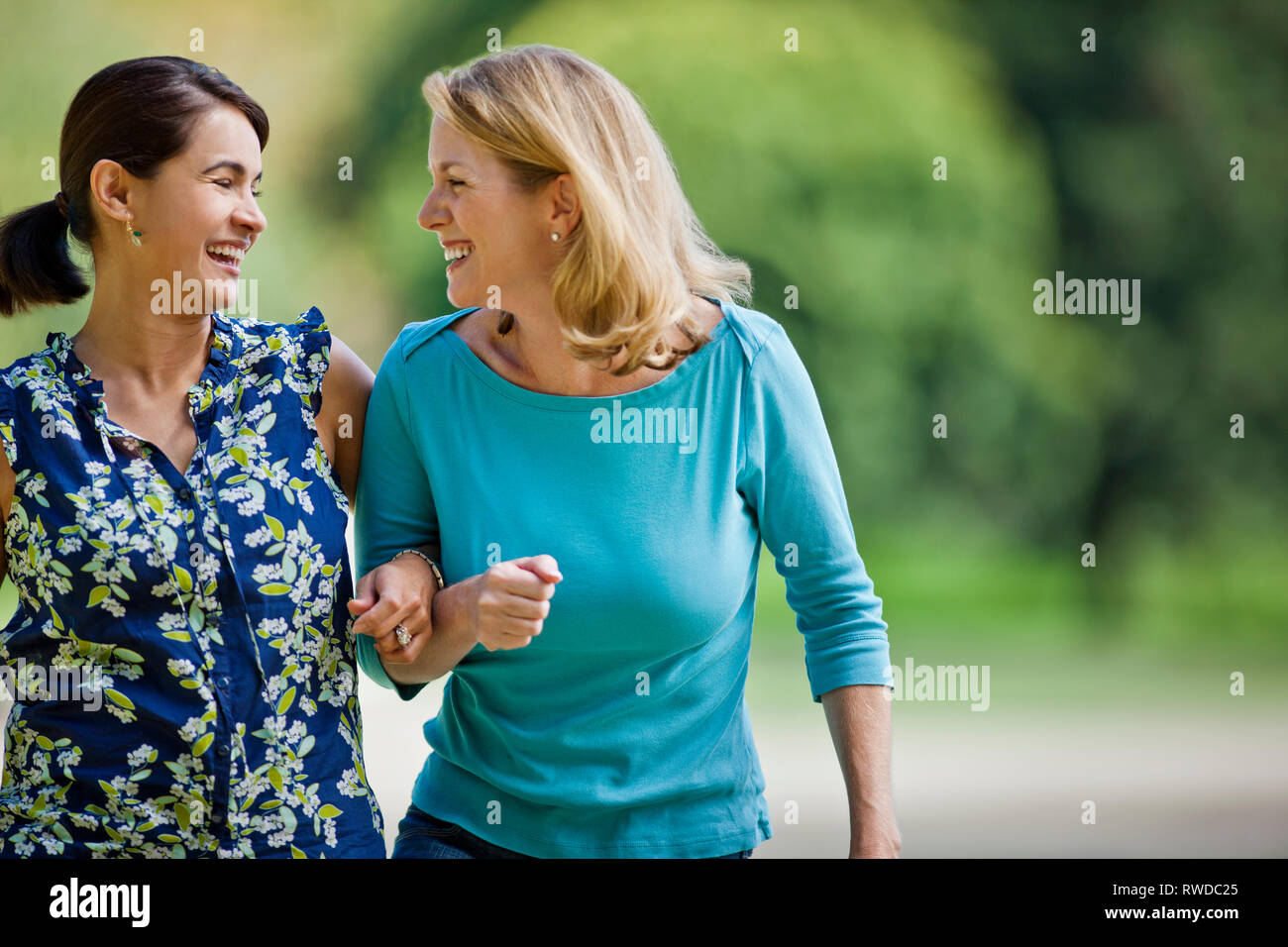 Two women walking arms linked hires stock photography and images Alamy