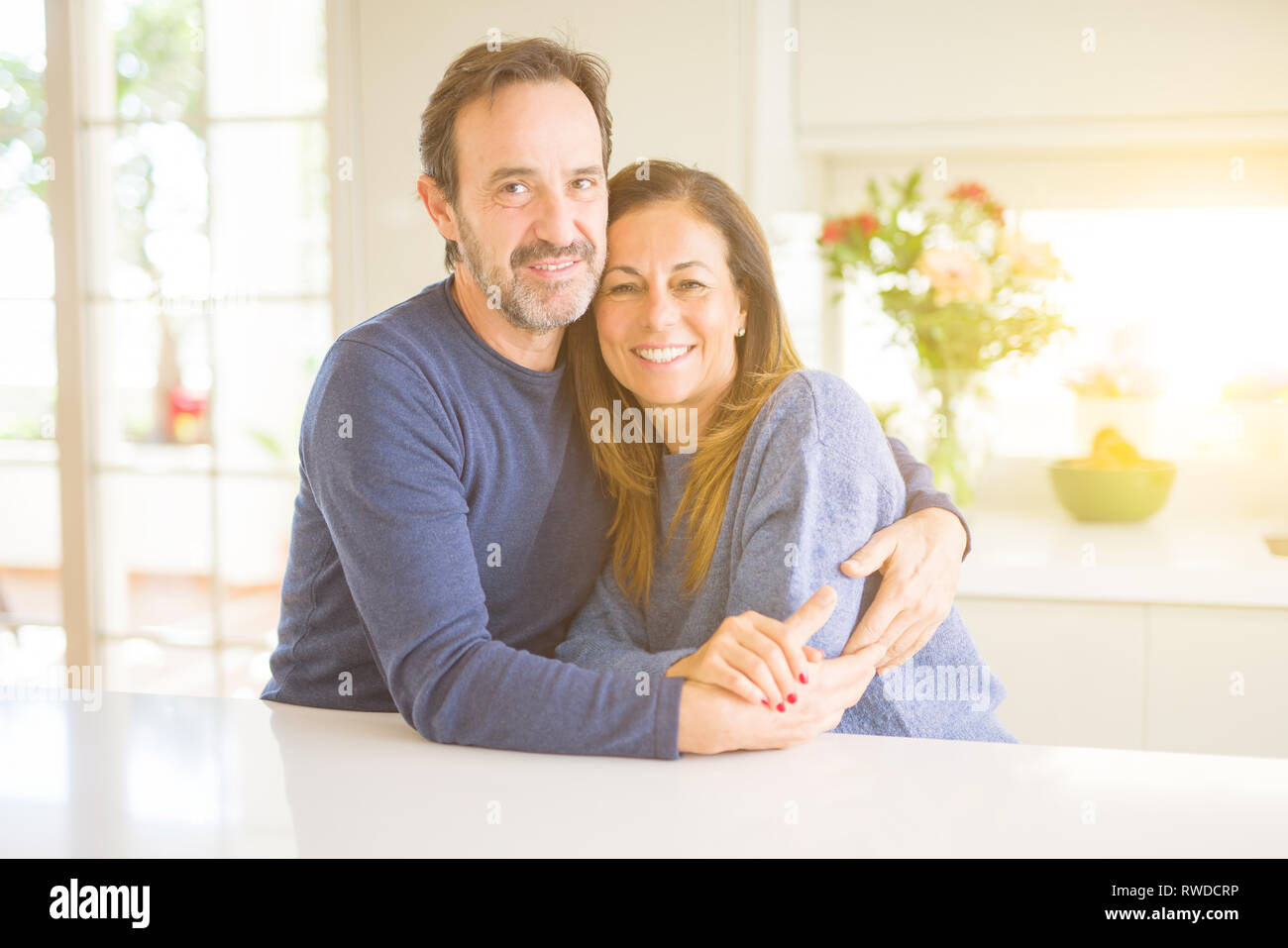 Romantic middle age couple sitting together at home Stock Photo - Alamy
