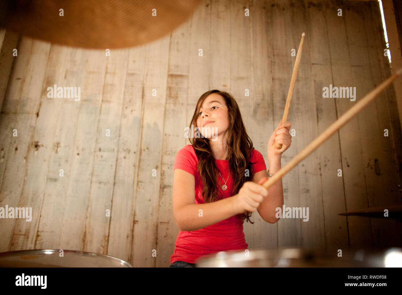 Teenage girl playing drums hires stock photography and images Alamy