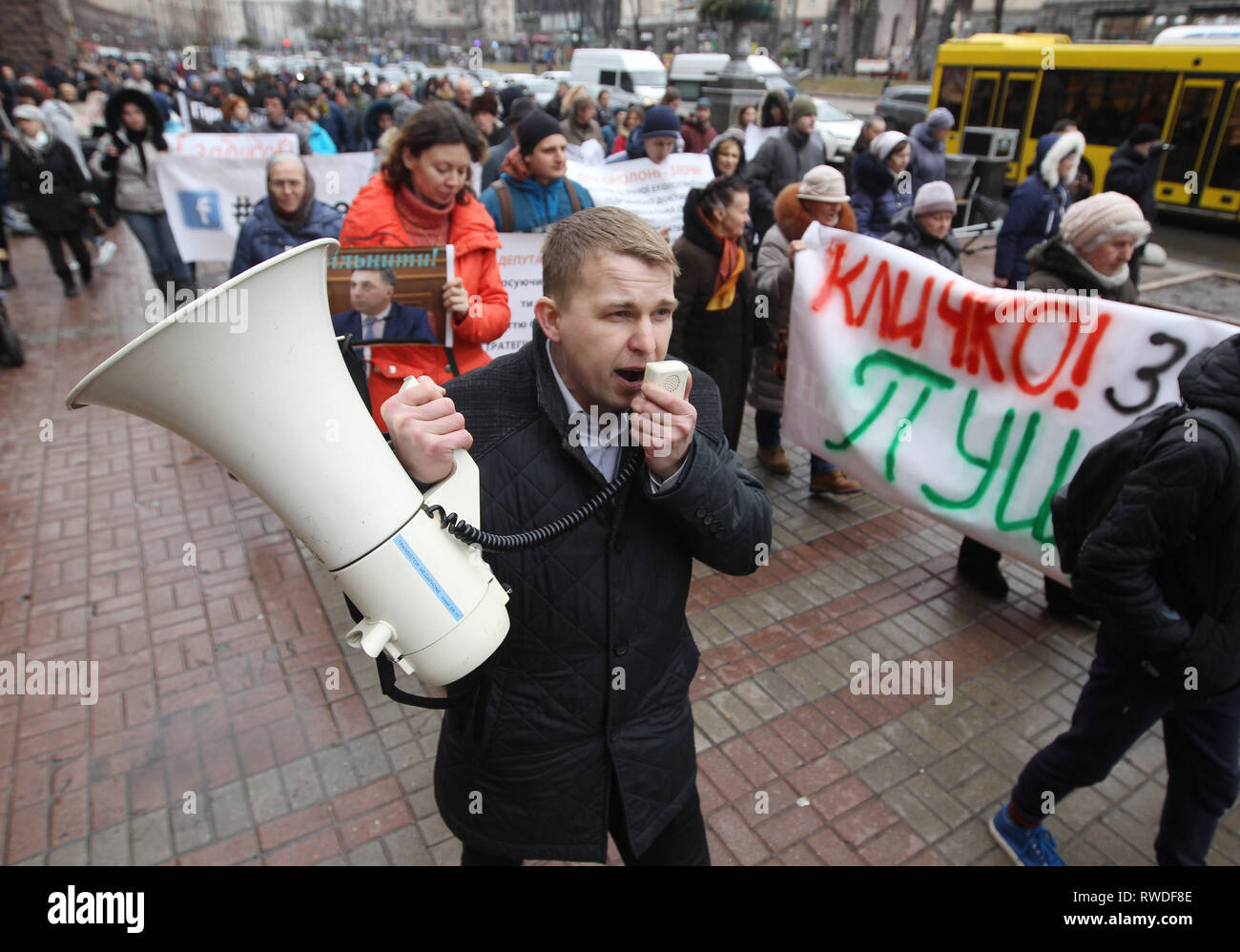 Ukrainian activist seen chanting slogans on a megaphone during the protest. Protest against illegal construction in Kiev, Ukraine,  the protesters held placards saying 'Save Kiev!', Mayor, stop corruption', 'We will not allow to demolish historical buildings!' and others as they demand that the mayor Vitali Klitschko and the city council to stop what they call illegal construction sites such as huge residential complexes and shopping malls and to preserve historical landscape of Kiev. Stock Photo