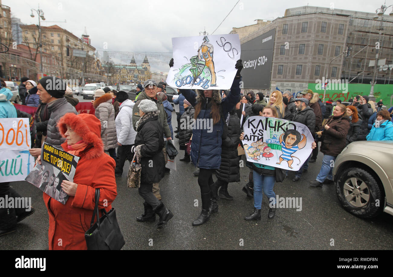 Ukrainian activists are seen holding placards while blocking road traffic along the central thoroughfare in front the Kiev City Hall, during the protest. Protest against illegal construction in Kiev, Ukraine,  the protesters held placards saying 'Save Kiev!', Mayor, stop corruption', 'We will not allow to demolish historical buildings!' and others as they demand that the mayor Vitali Klitschko and the city council to stop what they call illegal construction sites such as huge residential complexes and shopping malls and to preserve historical landscape of Kiev. Stock Photo