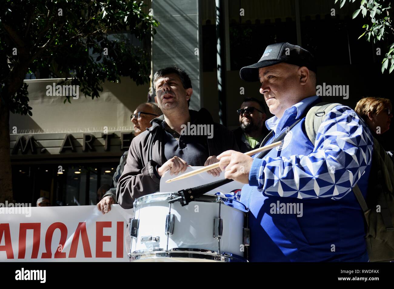 A Drummer Seen Before The Protesters Holding A Banner During The