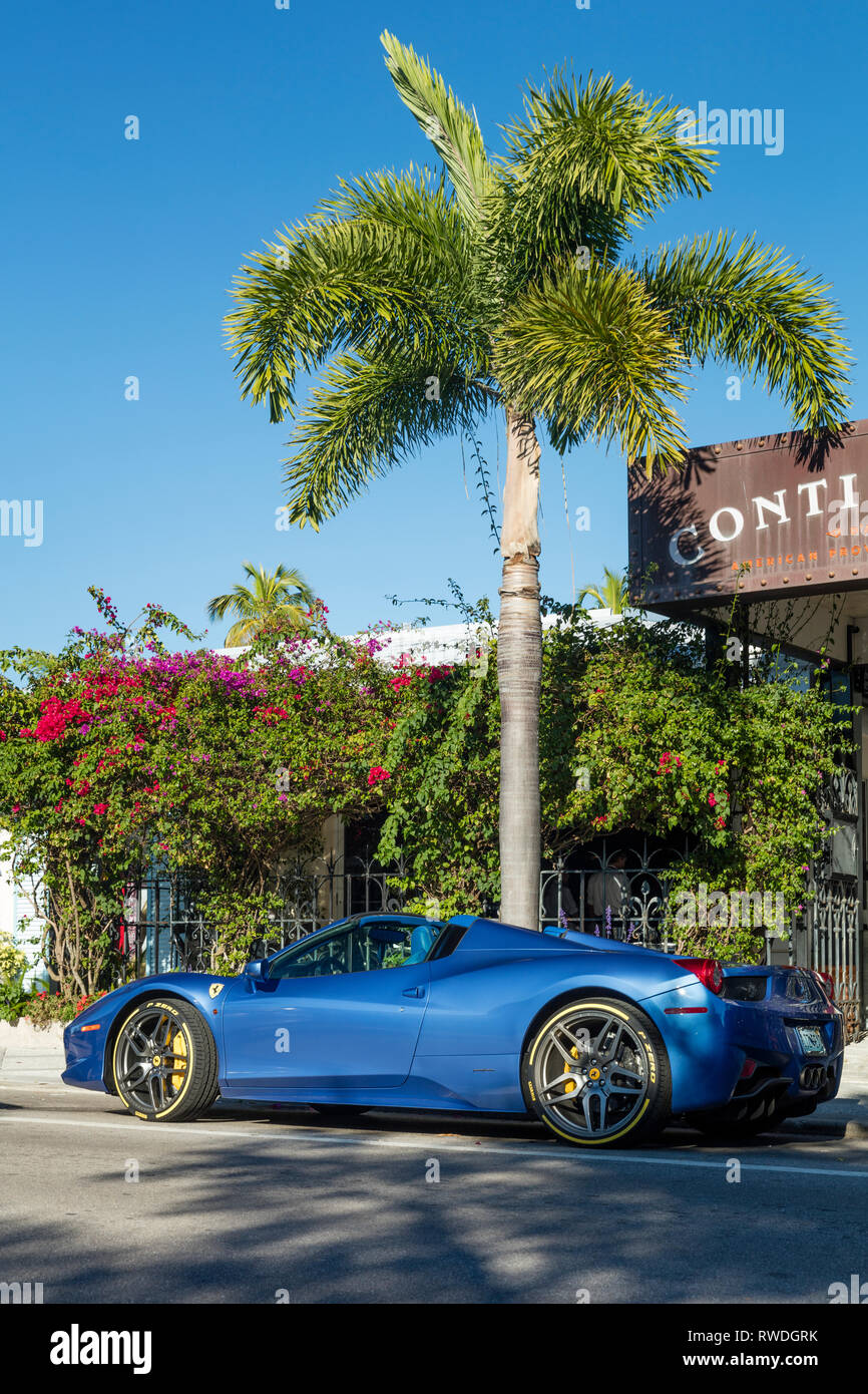 Blue Ferrari 458 parked along trendy 3rd Street South Shopping District, Naples, Florida, USA Stock Photo