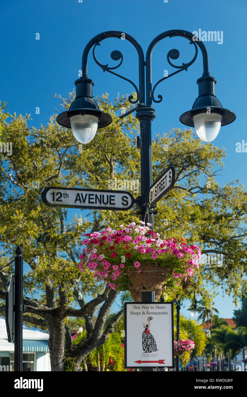Street signs, flowers and lamppost along trendy 3rd Street Shopping District, Naples, Florida, USA Stock Photo