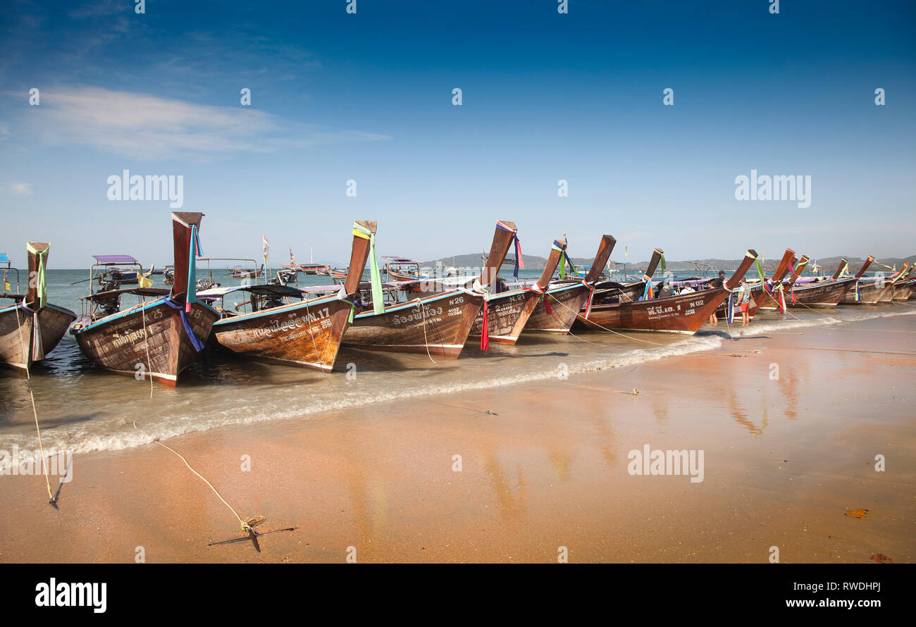 Long tailed boats for island hopping, Aonang, Krabi, Thailand, morning sun, boats waiting for hire to the islands Stock Photo