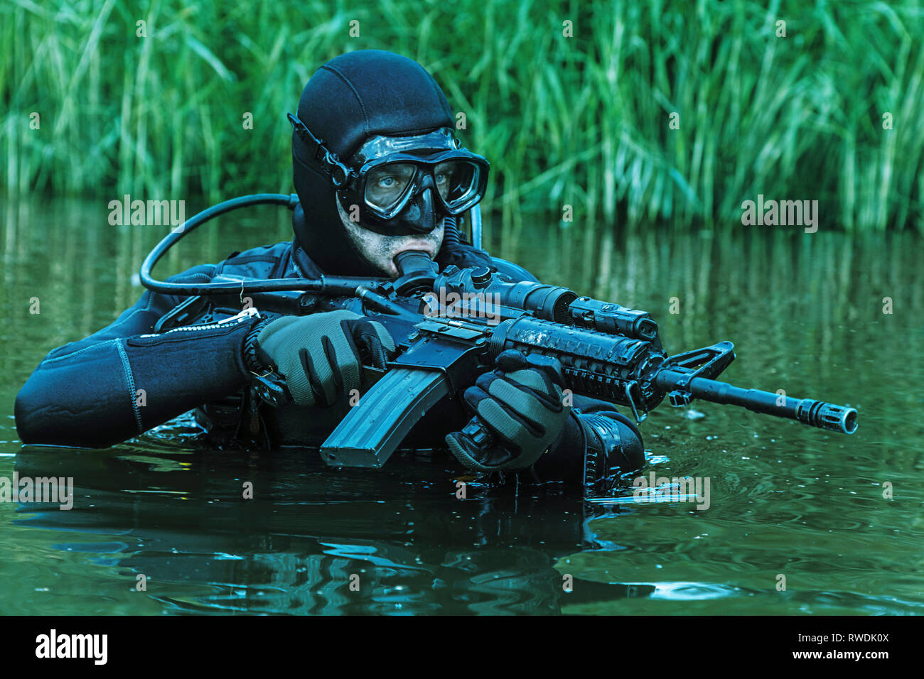 Frogman with complete diving gear and weapons in the water. Stock Photo
