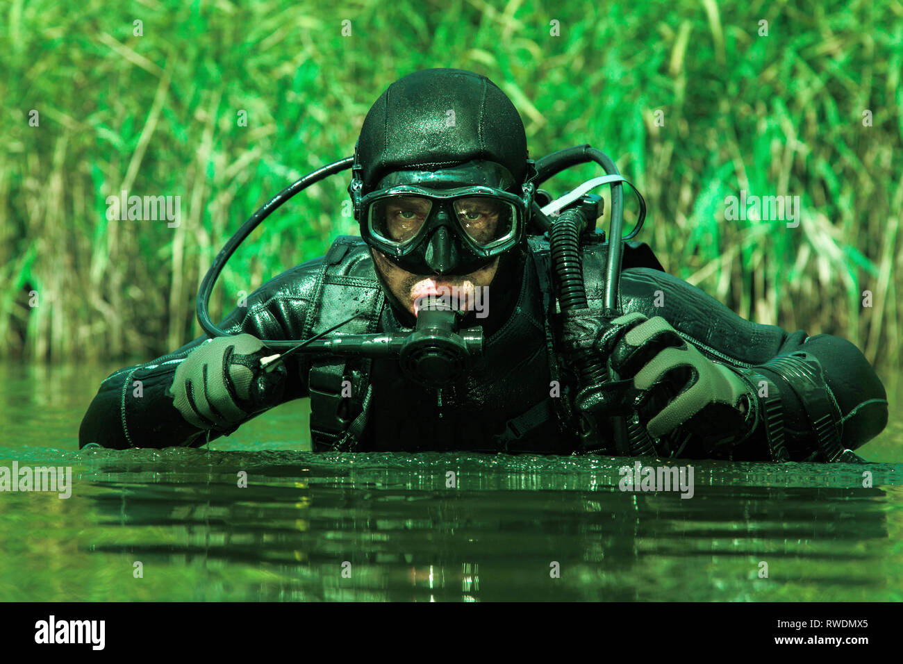 Frogman with complete diving gear and weapons in the water Stock