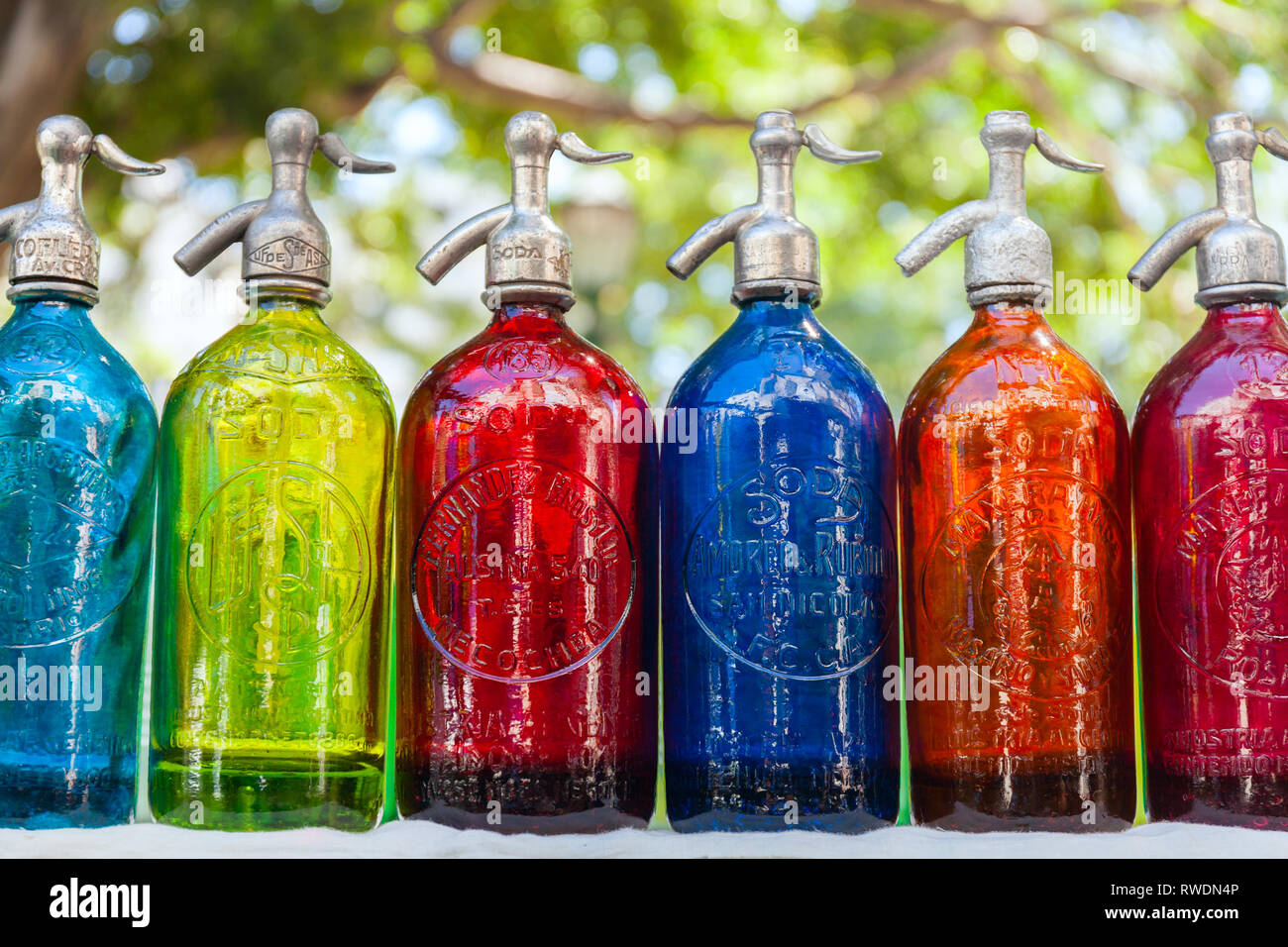 Antique Siphons bottles bright, colored Glass in Flea Market, Buenos Aires, Argentina Stock Photo