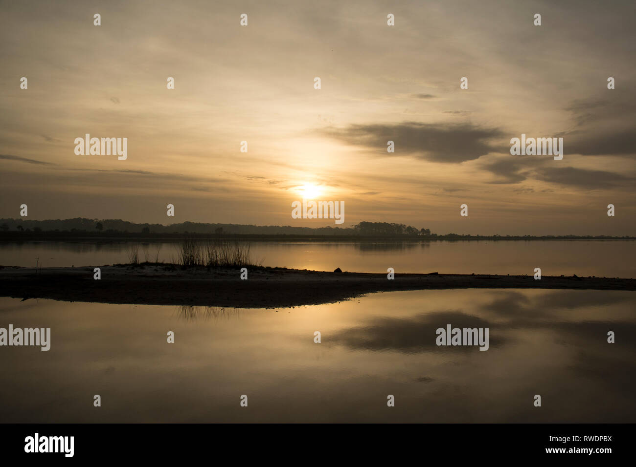 Sunrise over a lake on a misty morning Stock Photo - Alamy