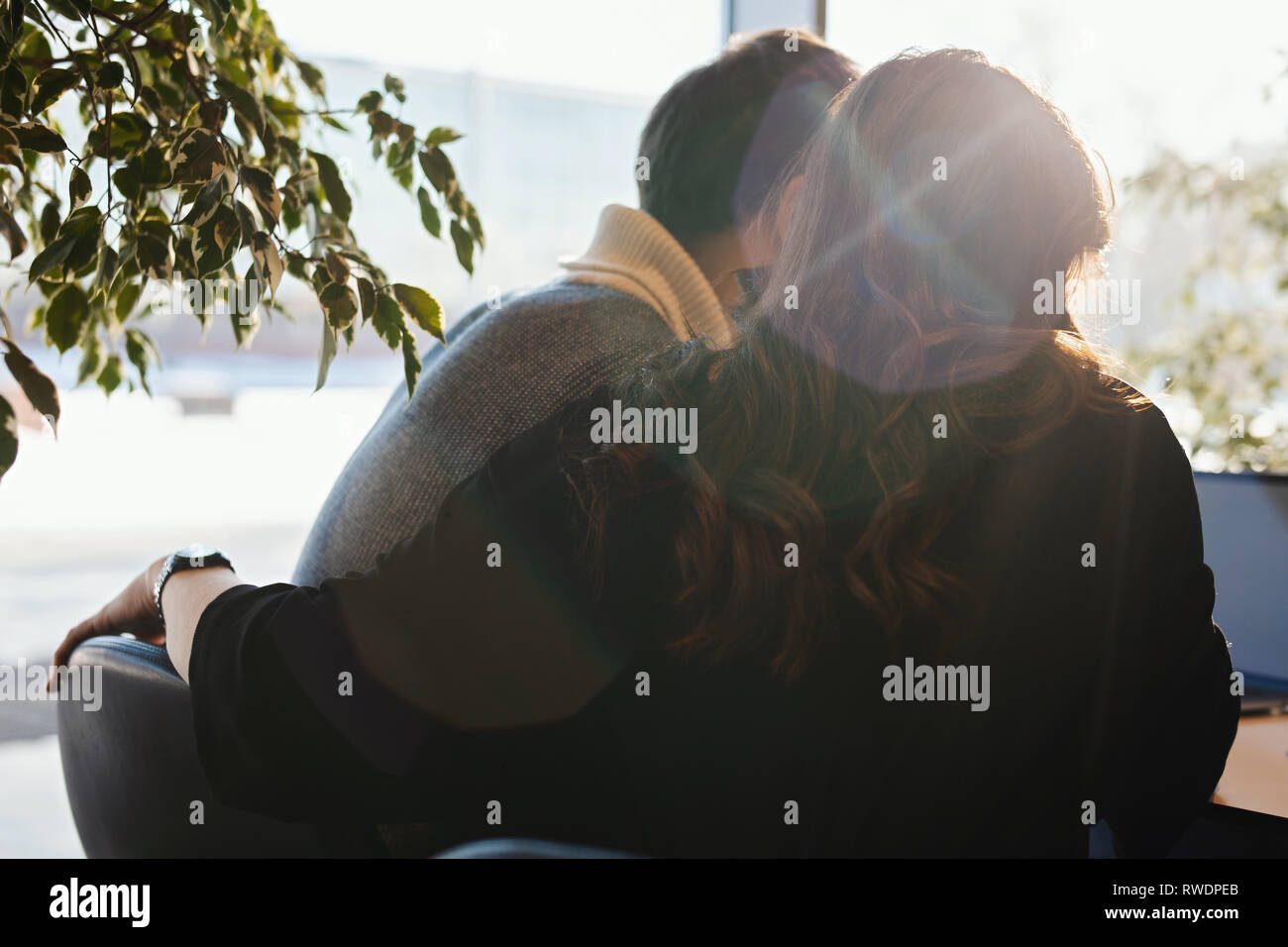 Young man and woman working in front of the laptop with blank white
